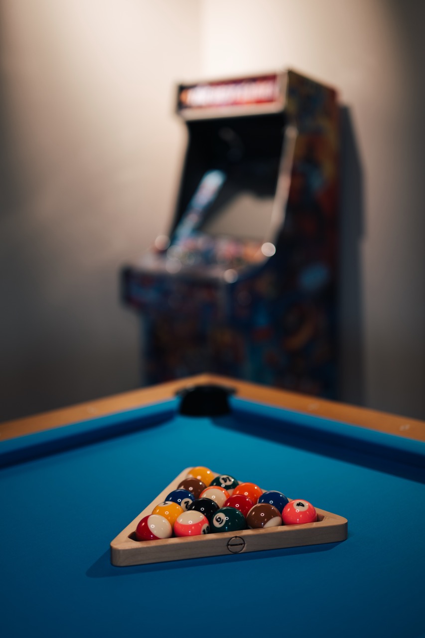 Pool table and arcade in the Kraków office games room